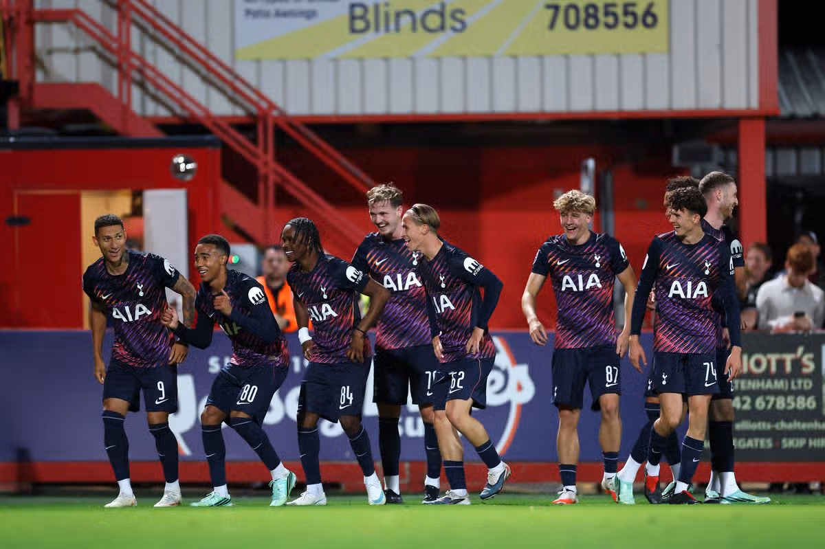 Richarlison celebrates with his youth teammates after scoring during the Jersey Mike's Trophy match between Cheltenham Town and Tottenham Hotspur U21s at The EV Charger Points Stadium.