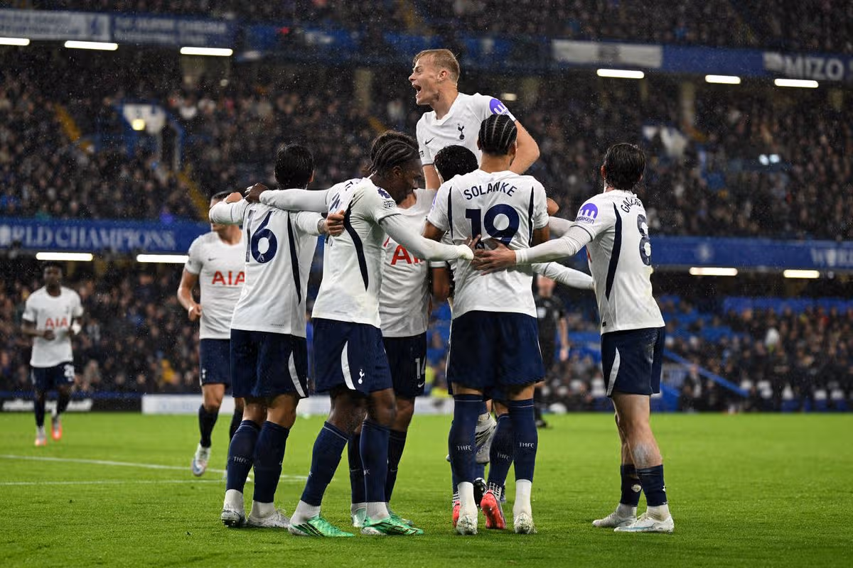 Tottenham Hotspur players celebrate after Mike Penders' own goal