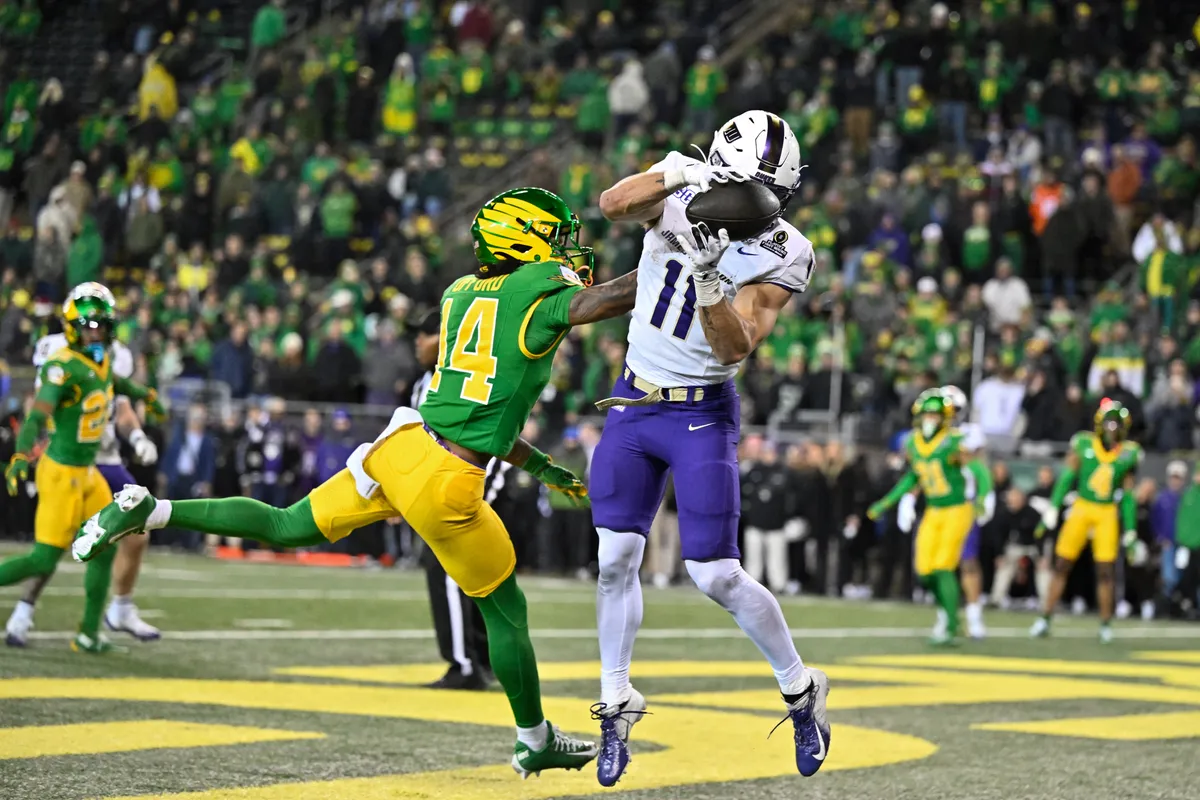 December 20, 2025; Eugene, OR, USA; James Madison Dukes wide receiver Nick Degennaro (11) catches for a touchdown as Oregon Ducks defensive end Na'Eem Offord (14) defends during the fourth quarter at Autzen Stadium. Mandatory credit: Craig Strobeck-Imagn Images