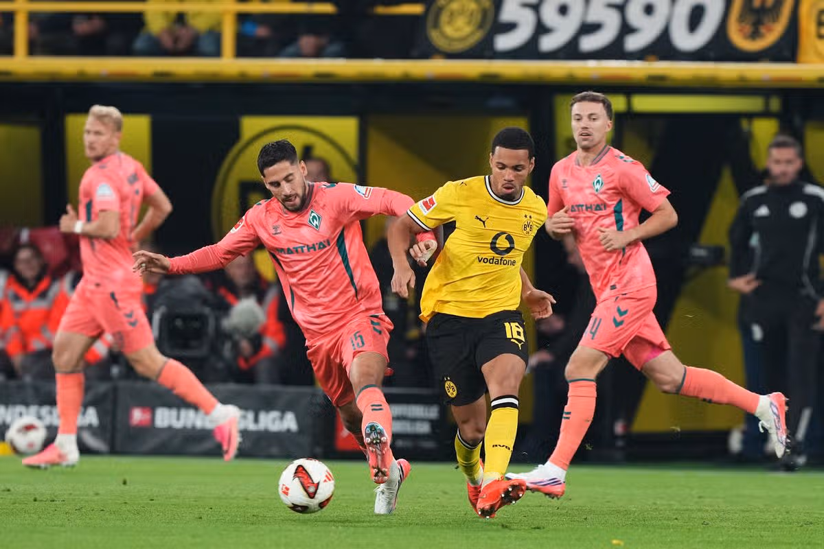 Dortmund's Ethan Nwaneri, right, and Bremen's Ludovit Reis fight for the ball during the German Bundesliga soccer match between Borussia Dortmund and Werder Bremen.