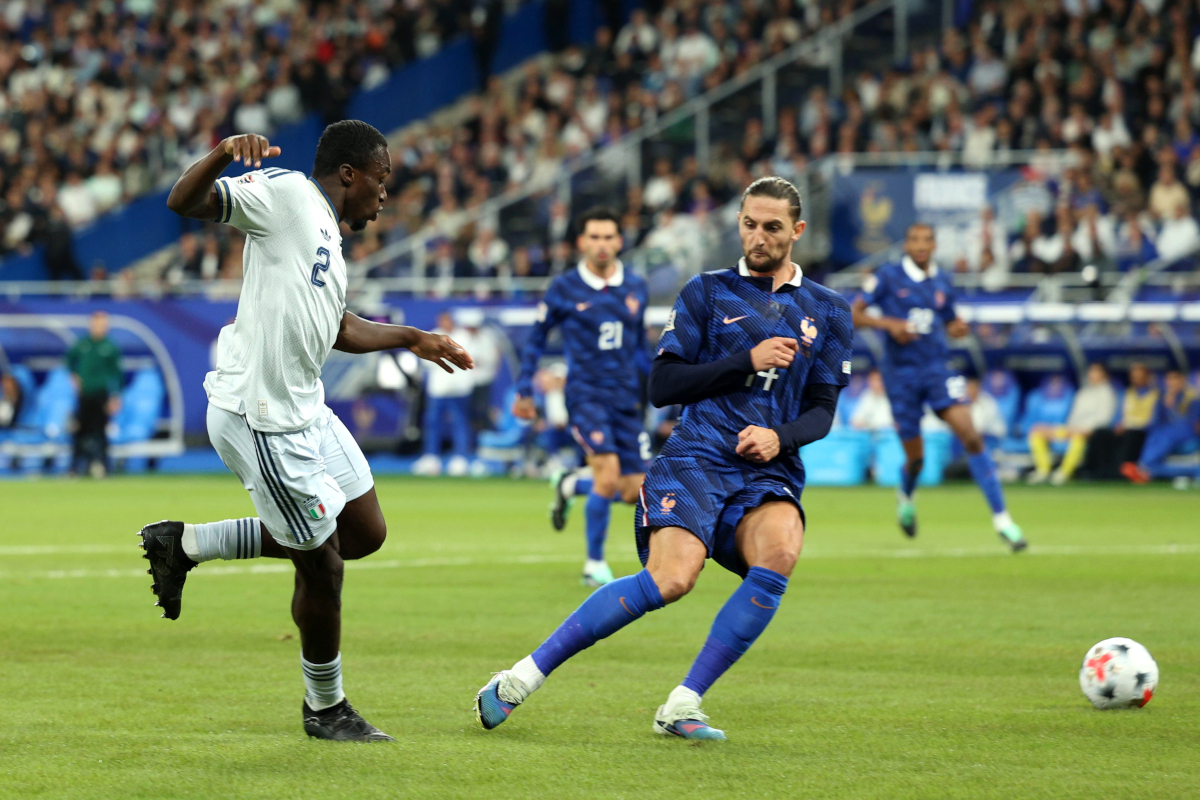 PARIS, FRANCE - OCTOBER 02: Michael Kayode of Italy passes the ball under pressure from France's Adrien Rabiot during the UEFA Nations League 2026/27 group stage match between France and Italy at Stade de France on October 02, 2026 in Paris, France. (Photo by Pauline Figuet/Getty Images)